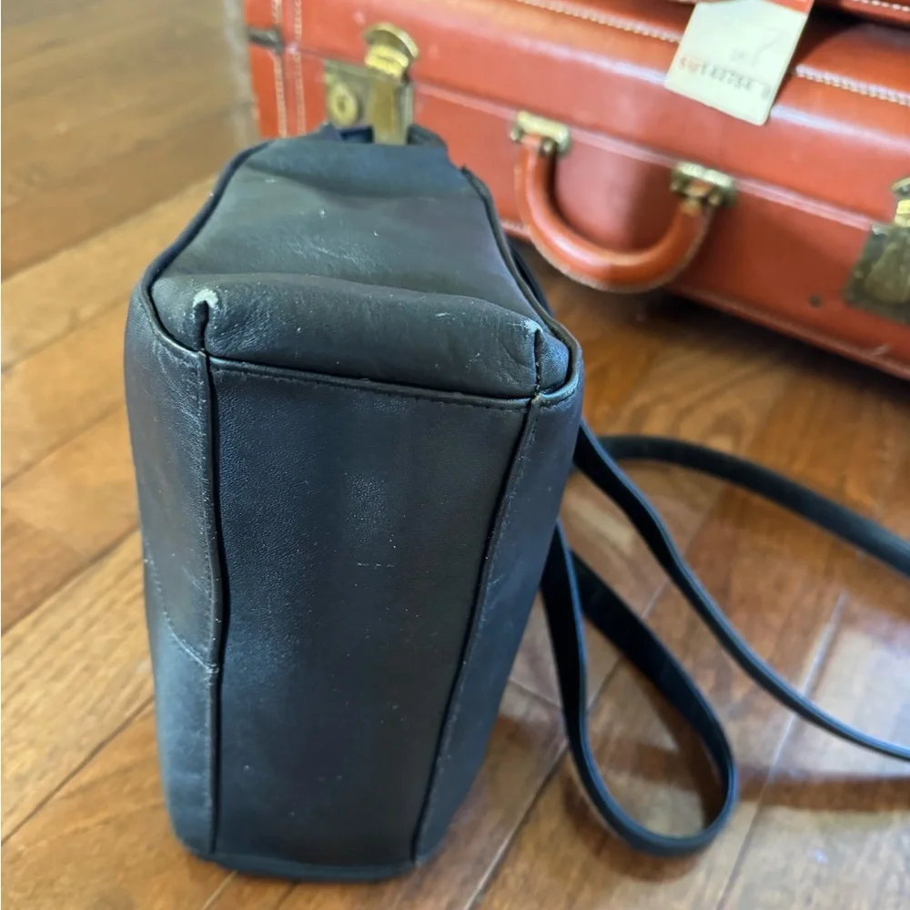Laura Scott Black shoulder bag with front and back outer pockets, snap closure.